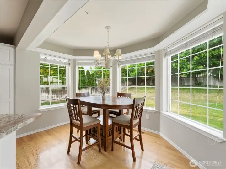 Bright dining nook overlooking the backyard and outdoor entertaining spaces.