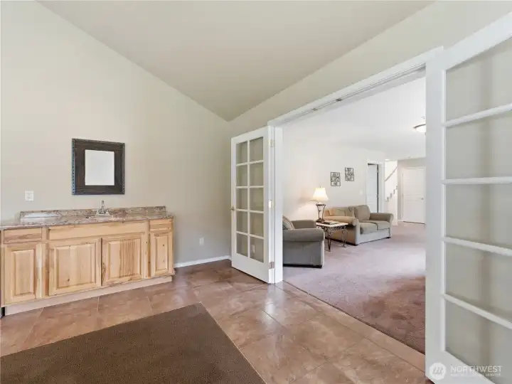 Spacious bonus room featuring a convenient wet bar, perfect for entertaining guests, game nights, or creating the ultimate media room.