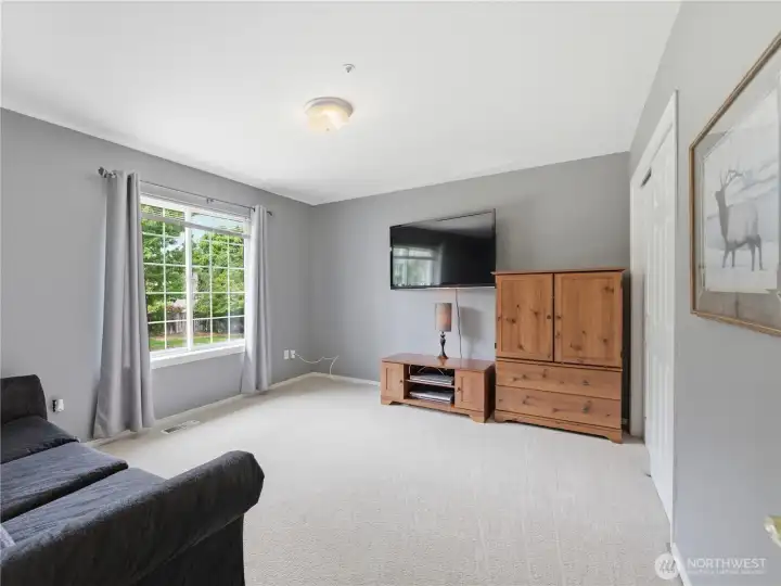 Bright guest bedroom with generous square footage and abundant natural light.
