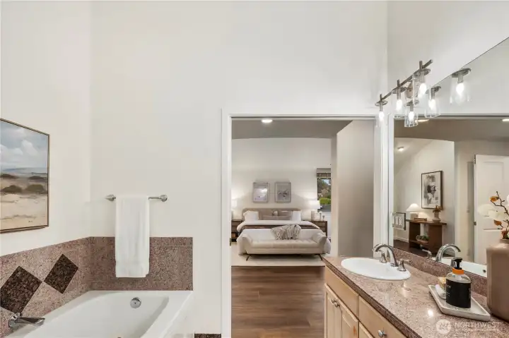 Sumptuous primary suite featuring a spacious walk-in closet and luxurious five-piece bath with soaking tub.