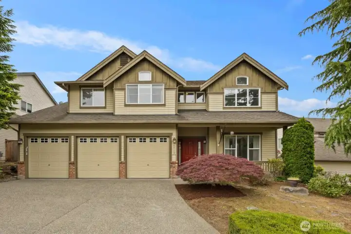 Spacious two-story home with a three-car garage, covered front porch, and established landscaping. Spacious two-story home with a three-car garage, covered front porch, and established landscaping.