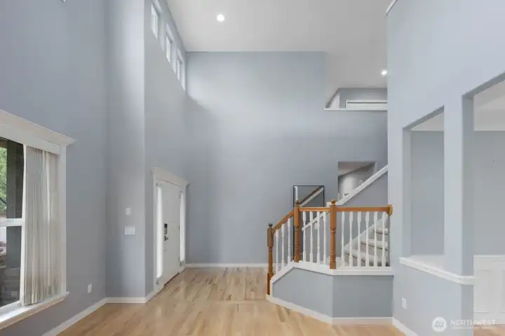 The grand entry features soaring ceilings, oversized windows, and an open staircase. The grand entry features soaring ceilings, oversized windows, and an open staircase.