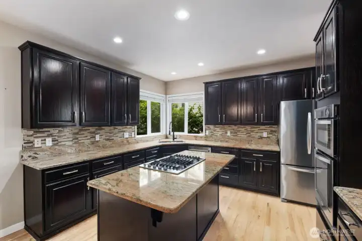 The kitchen and eating area open directly to the covered outdoor living space through sliding glass doors. The kitchen and eating area open directly to the covered outdoor living space through sliding glass doors.