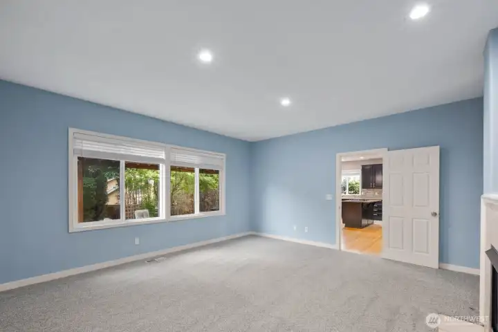 Large windows fill the room with natural light while maintaining views of the private outdoor space. Large windows fill the room with natural light while maintaining views of the private outdoor space.