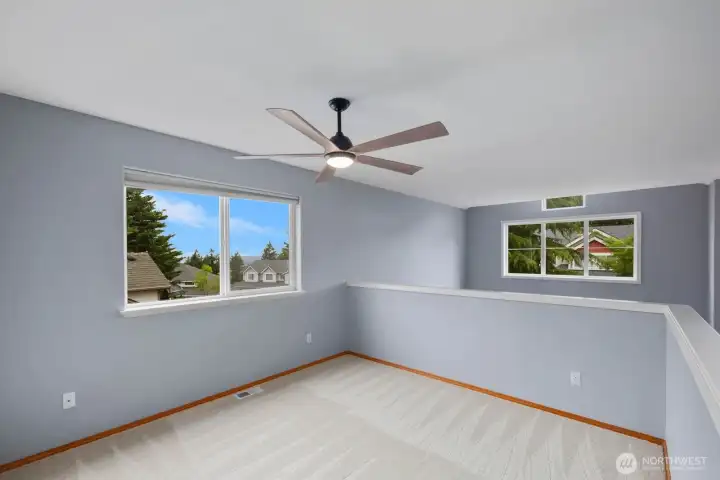 Spacious upper-level bonus area filled with natural light from multiple windows. An open layout offers flexibility for a media room, home office, hobby space, or additional gathering area. Spacious upper-level bonus area filled with natural light from multiple windows. An open layout offers flexibility for a media room, home office, hobby space, or additional gathering area.