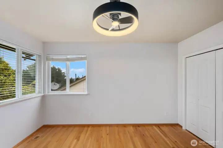 Additional view of the bedroom highlighting the hardwood flooring, generous wall space, and closet storage. Additional view of the bedroom highlighting the hardwood flooring, generous wall space, and closet storage.