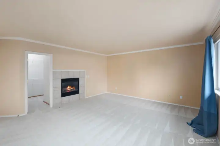 Another view of the primary bedroom showcasing the fireplace, generous room size, and direct access to the adjoining primary bathroom. Another view of the primary bedroom showcasing the fireplace, generous room size, and direct access to the adjoining primary bathroom.