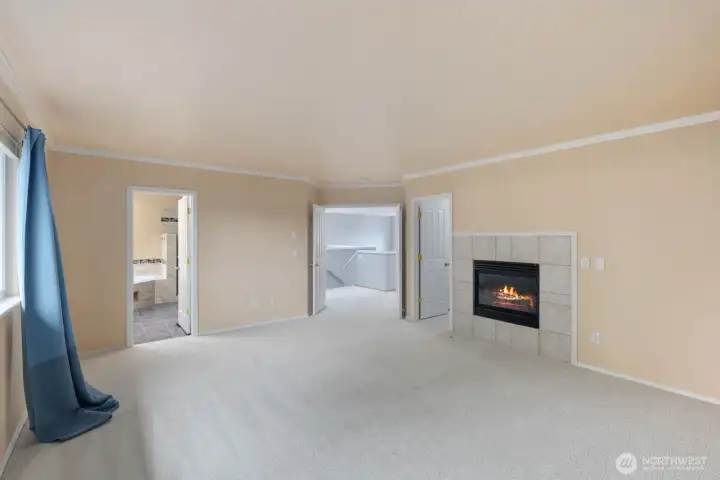 Primary bedroom with large windows, gas fireplace, and a spacious layout designed for comfort and flexibility. Natural light and an open feel make this room a standout feature of the home. Primary bedroom with large windows, gas fireplace, and a spacious layout designed for comfort and flexibility. Natural light and an open feel make this room a standout feature of the home.