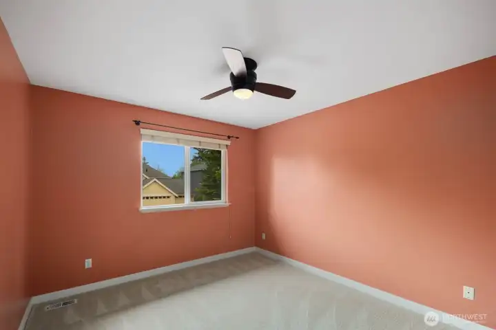 Bedroom featuring a large window, ceiling fan, and comfortable layout. Natural light creates a bright and welcoming atmosphere throughout the space. Bedroom featuring a large window, ceiling fan, and comfortable layout. Natural light creates a bright and welcoming atmosphere throughout the space.
