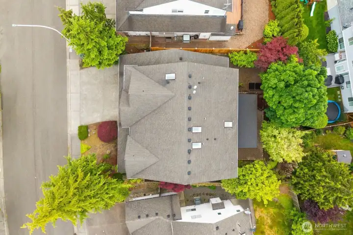 Aerial view highlighting the home's footprint, backyard space, mature landscaping, and surrounding neighborhood setting. Aerial view highlighting the home's footprint, backyard space, mature landscaping, and surrounding neighborhood setting.