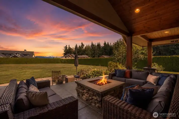 The patio's vaulted ceiling shelters a built-in firepit- perfect for year-round entertaining.