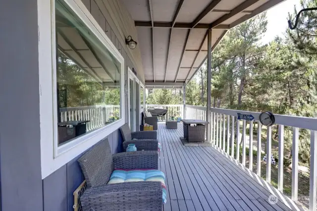 The main floor covered wrap-around deck with barbeque and propane firepit.