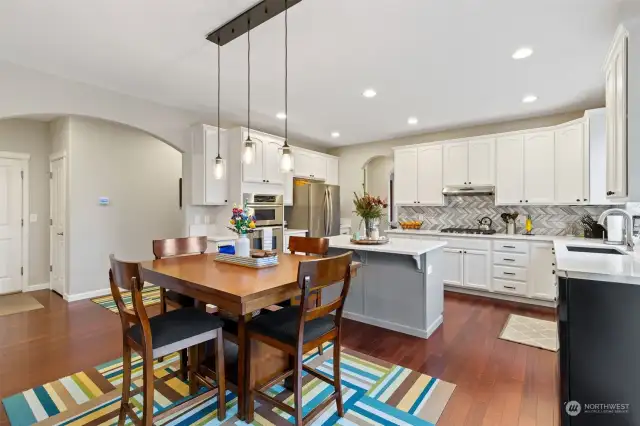 Another view of informal eating area and kitchen. Doors on left are to garage and storage space.  Not shown is doorway to 1/2 bath on left of garage entry.