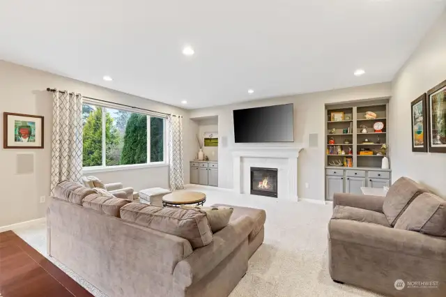 Family room with gas fireplace and built-in cabinetry.