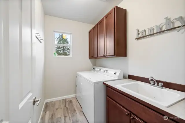 Laundry room with utility sink and storage