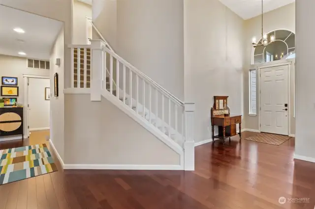 Entry foyer, den to right of front door, stairway to bedrooms, hallway to family room, 1/2 bath, garage entry