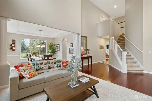 Living room view toward dining room, stairway to upper level