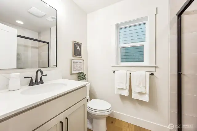 Beautiful main floor 3/4 bath with bedroom on the main floor. Photos are of the Magnolia model home at Maywood Heights on lot 8. Photos are for illustration purposes only; colors and finishes will vary.