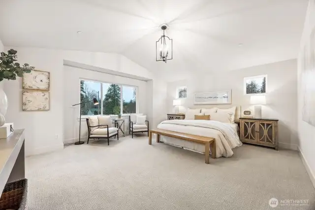 Elegant primary suite with vaulted ceilings and expansive windows. Photos are of the Magnolia model home at Maywood Heights on lot 8. Photos are for illustration purposes only; colors and finishes will vary.