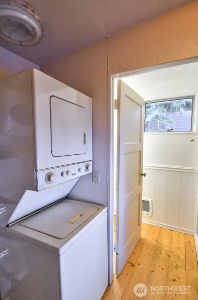 Stackable washer and dryer and looking into the bathroom