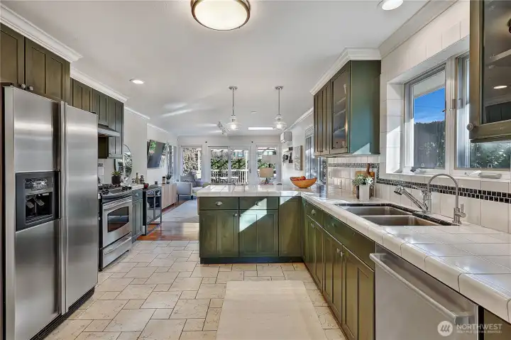 Open kitchen features abundant storage and countertop space and breakfast bar