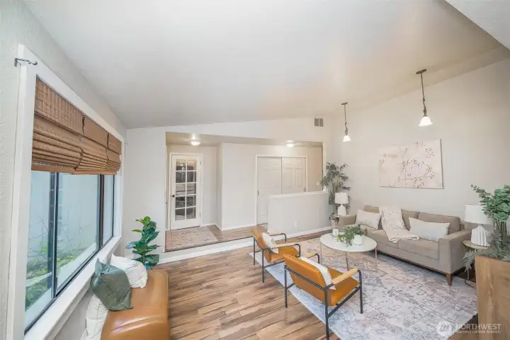 Sunken living space with vaulted ceilings and gorgeous laminate floors.