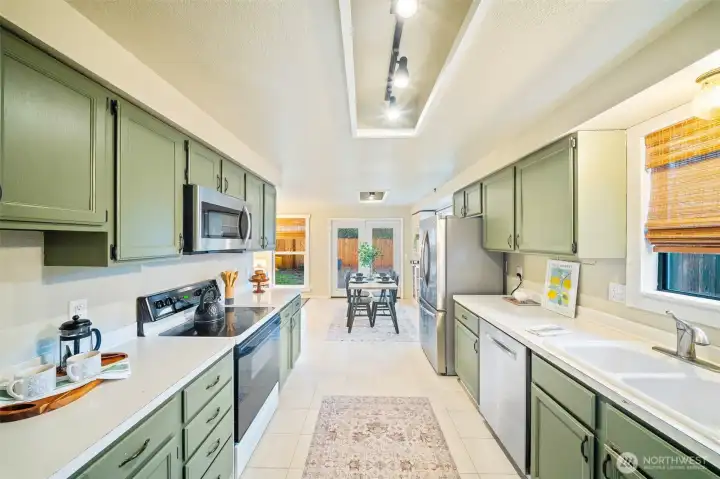 Another view of the kitchen leading into another eating space.