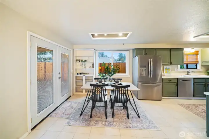 Light and bright kitchen|dining area with recessed lighting.