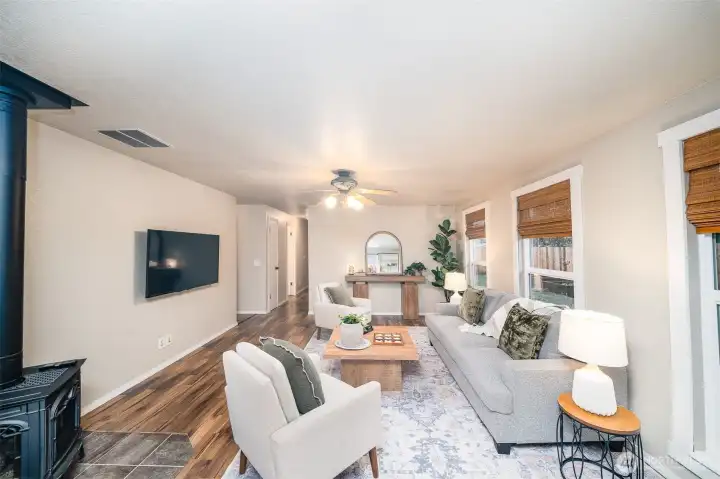 Living area with cozy propane stove!  Window coverings and TV included!