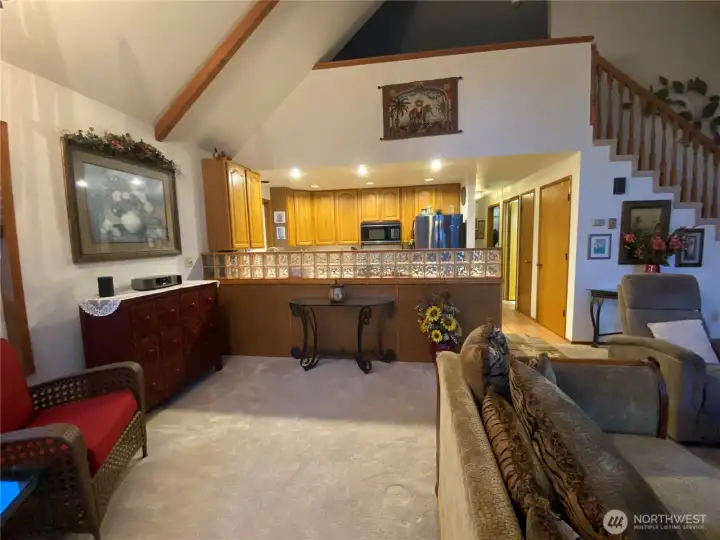 Wider angle of kitchen, hall and loft