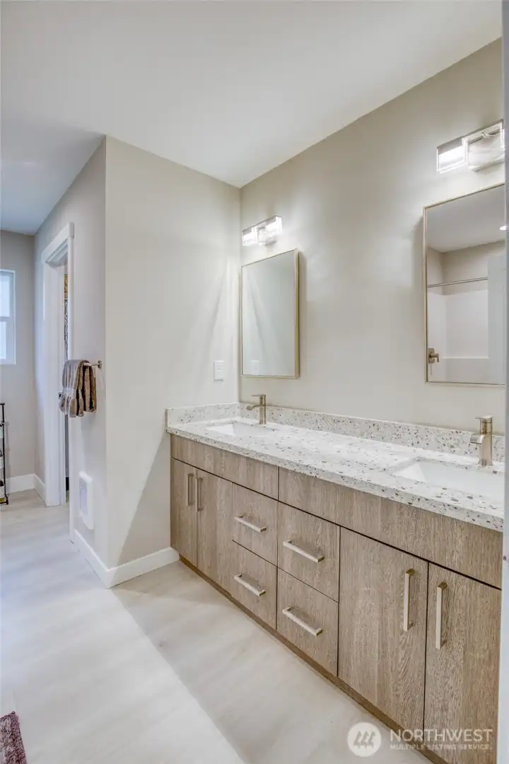 Primary bath with double vanity and quartz countertops