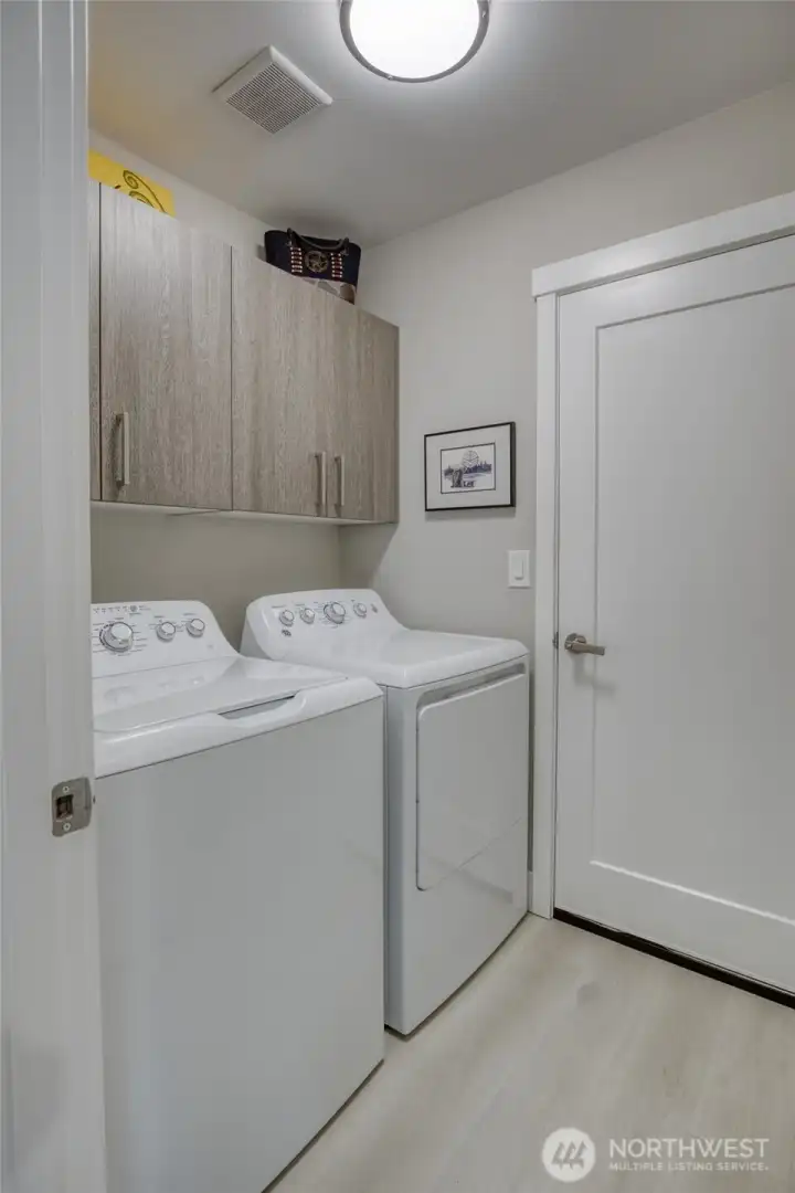 Laundry room with storage leads to 2 car garage