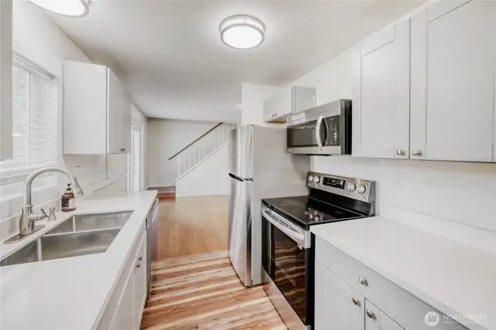 Modern kitchen workspace with elegant quartz counters and stainless steel appliances. A standout feature in this beautifully updated 1,690 sq ft residence with top-rated schools just minutes away in Union Hill.