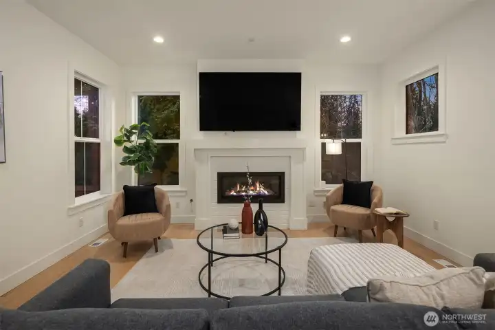 This inviting great room feels warm and intimate. The fireplace is sleek in design with media hook up above.