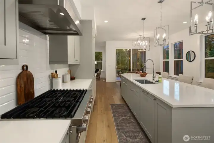 You'll love cooking on this oversized gas stovetop with six burners and sleek stainless-steel hood above.