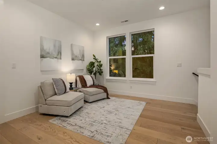The upper-level landing has a nice generous space for reading nook or office area.