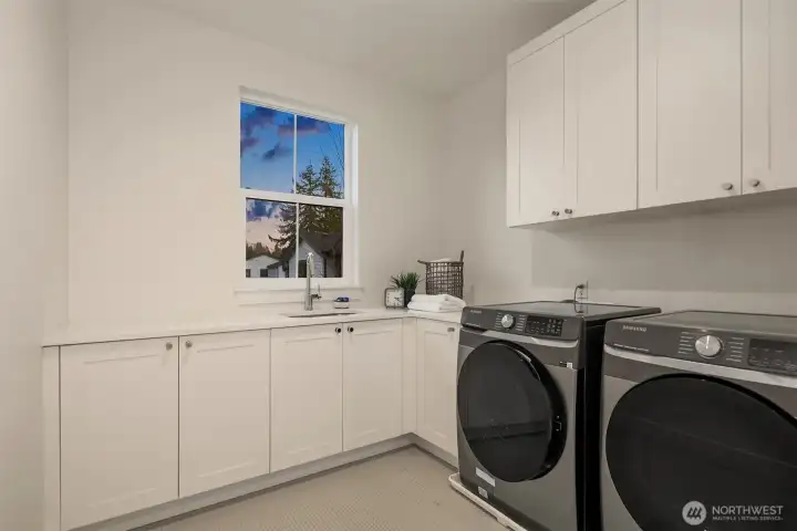 A large, upstairs laundry room combines practicality with polished design making everyday tasks feel organized and effortless.