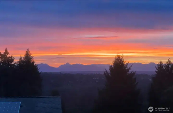Owner provided sunset images, shot from living room.  NOT from drone.