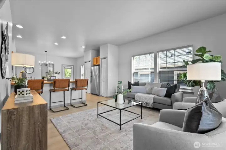 The spacious living room offers flexible furniture placement with large windows that bring in abundant natural light.