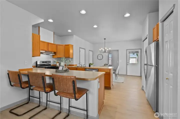 The kitchen features extensive cabinetry, generous counter space, and multiple seating areas for casual dining and entertaining.