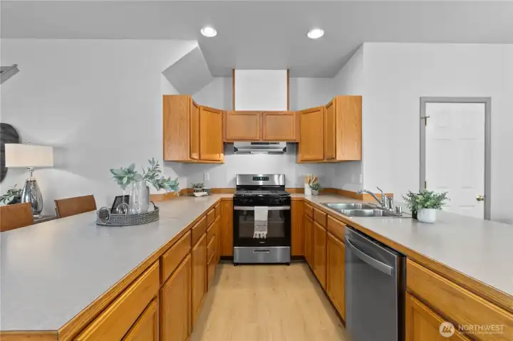 New stainless steel appliances, abundant cabinetry, and an efficient layout make meal preparation both functional and convenient.