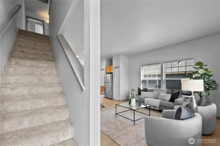 A welcoming entry opens to a bright, comfortable living space with an open layout that creates an easy flow between the living area and kitchen.