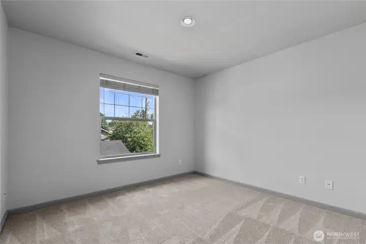 Versatile second bedroom with ample closet space and natural light, ideal for guests, a home office, or additional living needs.