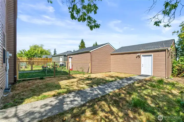 Low-maintenance fenced backyard offers space for pets, gardening, or outdoor relaxation, with access to the detached garage.