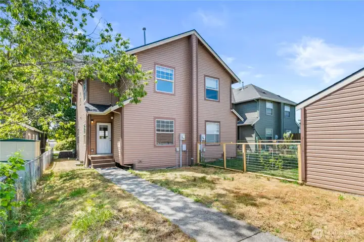 Enjoy a private backyard with fenced outdoor space and a detached garage providing additional storage and parking.