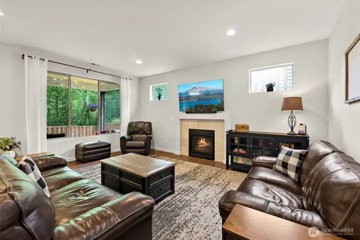 Large, Open Living Room with cozy gas fireplace and plenty of natural light