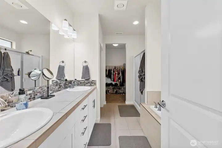 Primary Bath with two sinks and plenty of countertop space and storage underneath