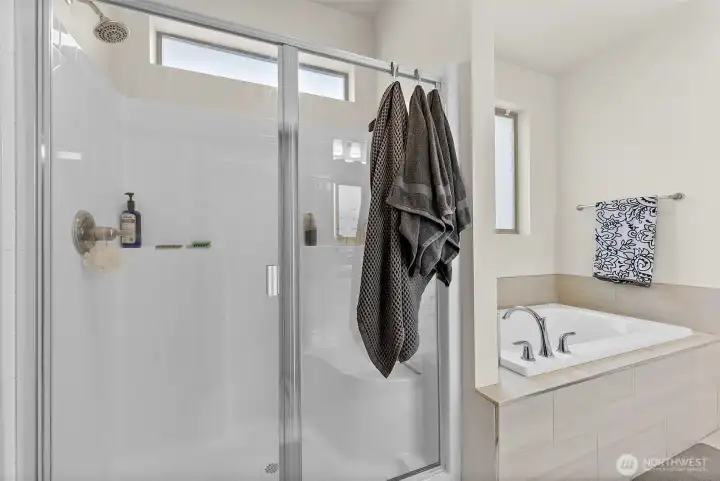Spacious shower and a tub for a relaxing bath