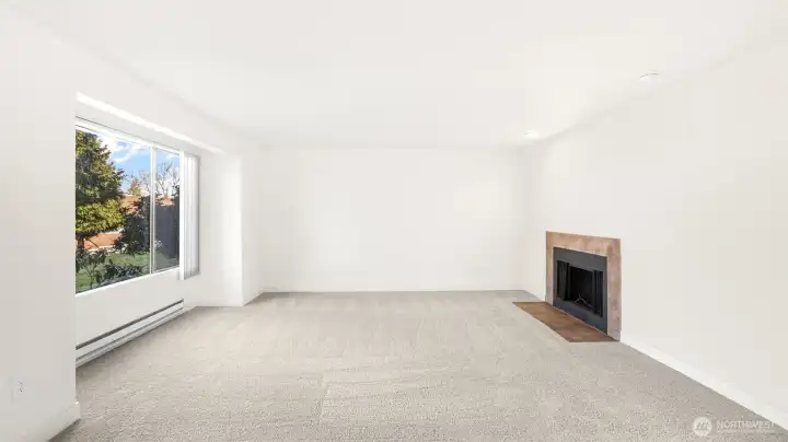 The living room offers the perfect ambiance with the natural light and the cozy fireplace.