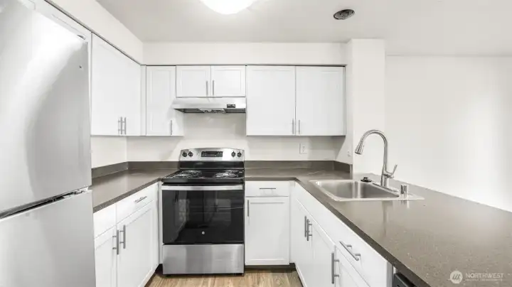 White shaker cabinetry, sleek countertops, plenty of storage & all appliances stay.